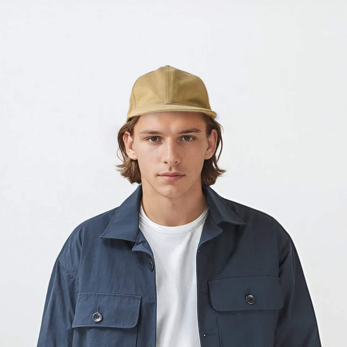 Studio portrait of model wearing the Chino Six Panel Ball Cap, demonstrating the classic fit and brim curve from front angle