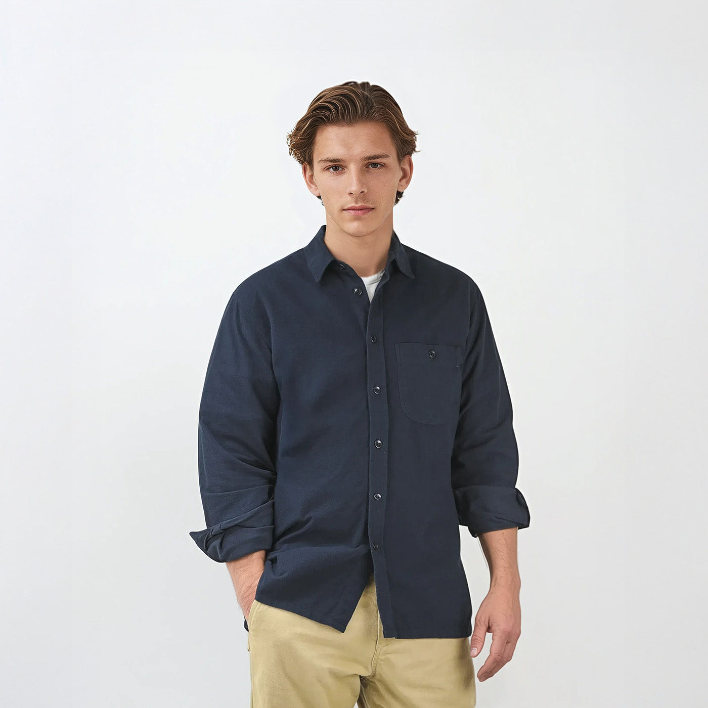 Model wearing Kerrin navy flannel shirt in studio setting, front view to show relaxed fit, single pocket and natural corozo buttons. Made from 100% Japanese cotton fabric with straight hem detail.